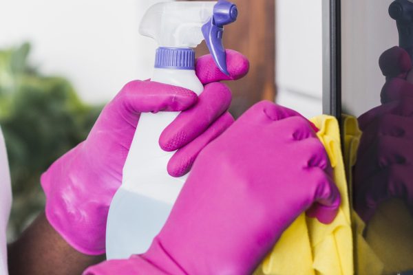 close-up-hands-holding-cleaning-supplies